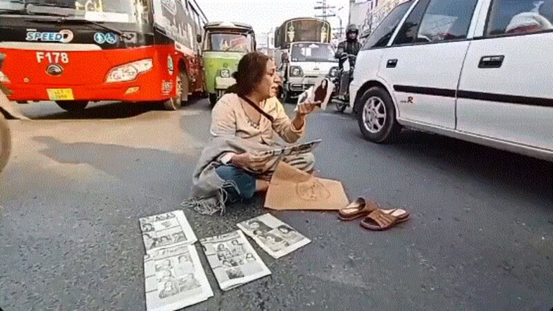 Elderly woman sits in oncoming traffic to protest the disappearance of her daughter