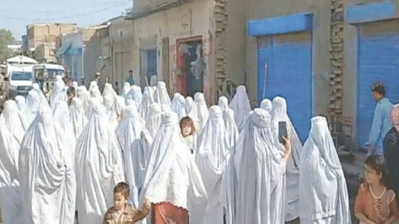 Women in burqas join men to protest against power outages