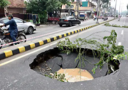 Sinkhole opens near Shaukat Khanum after heavy rain inundates Lahore; one dead in separate incident